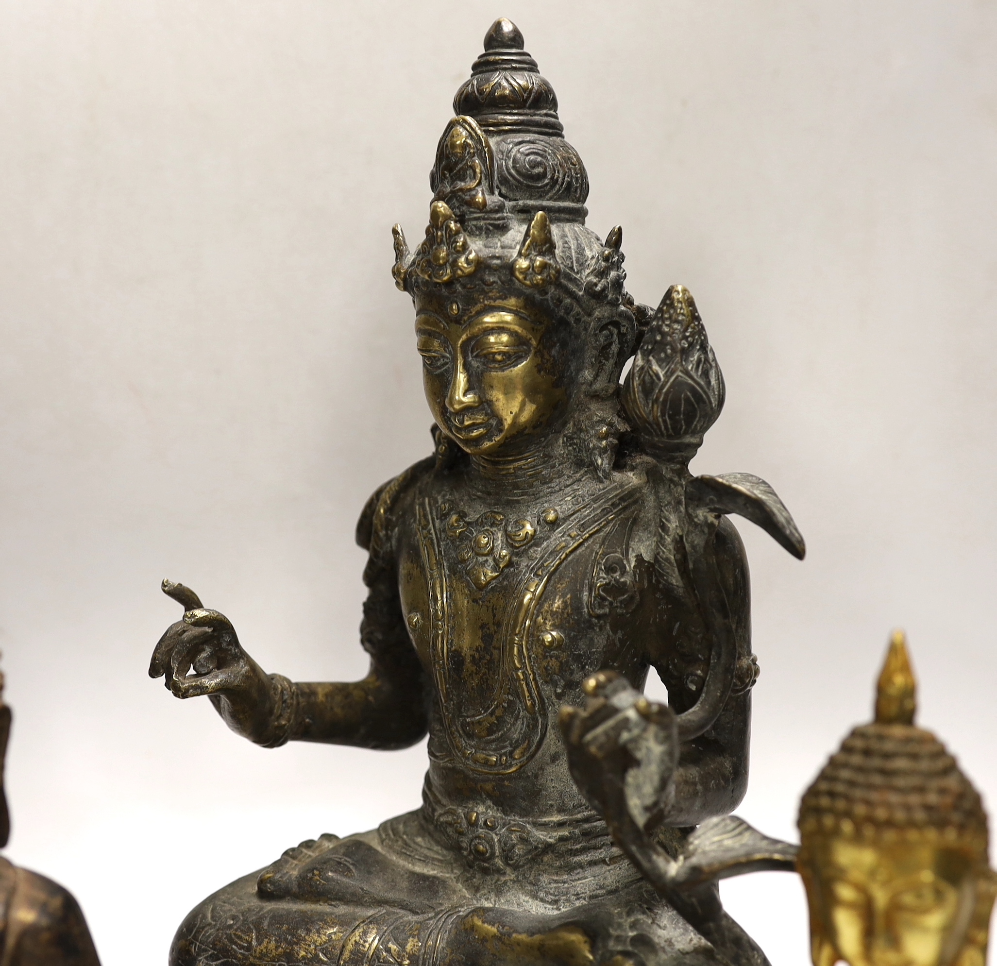 Four Thai and far-eastern bronze figures of the Buddha, tallest 28cm